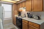 The kitchen is sunny and well-equipped with a Refrigerator, Stove, Coffee Maker, Cookware, Electric Oven and Range, Dishwasher and Microwave